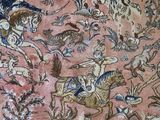 an image of a very old rug with a lot of animals on it