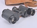 a pair of binoculars sitting on a table next to a bag