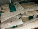 many bags of food sitting on a shelf in a refrigerator