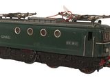 a green train car that is sitting on the tracks