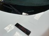 a sticker on the hood of a white sports car
