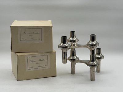 two silver candles are sitting next to each other in a box
