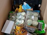 a cardboard box filled with cans and cans of food