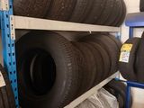 many tires stacked on a shelf in a store
