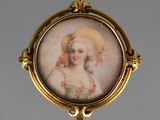 portrait of a woman in a bonnet in a gold broochle