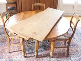 an image of a dining room table with chairs and a rug