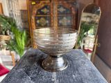 a glass bowl sitting on top of a wooden table