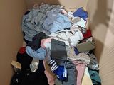 a cardboard box filled with clothes and other items