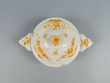 an orange and white bowl sitting on top of a table