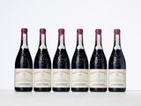 six bottles of wine lined up in a row on a table