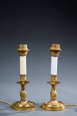 pair of antique brass candlesticks with frosted glass shades