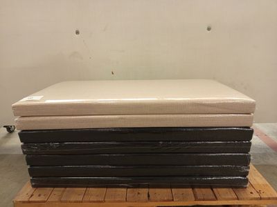 a stack of mattresses sitting on a pallet in a warehouse
