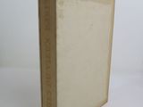 an old book sitting on top of a white table