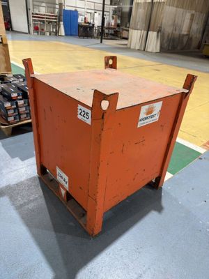 a large orange box sitting on a dolly in a warehouse