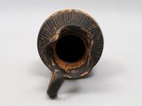 a black and brown vase with a hole in it