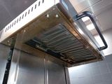 an image of a commercial kitchen with a venter over the stove
