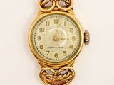 an image of a close up of a wrist watch on a white surface