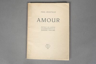 an old book sitting on top of a table next to a gray table