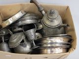 a box full of old silver pots and pans