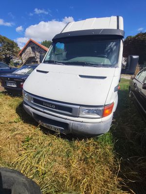 a white van that is parked in the grass