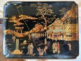 a black tray with a painting of people on it