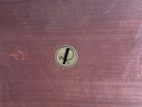 a brown wooden table with a black and white logo on it