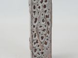 a white vase with a design on it on a white surface