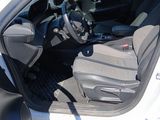 the interior of a car with the door open and the driver ' s seat down