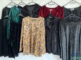a lot of clothes that are hanging on a clothes rack