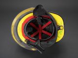 a fireman ' s helmet with a red cross mark on it