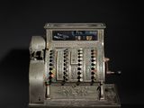 an old fashioned cash register on a black background
