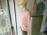 a mannequin in the window of a clothing store