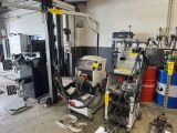 a machine that is sitting in a garage with other machines