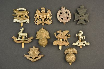 some of the badges are gold and silver on a black background