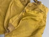 an old pair of yellow pants sitting on top of a table