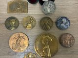 some of the medals are sitting on a wooden table