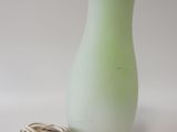 a green glass vase with a cord attached to it