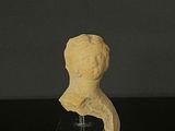 a small statue of a woman on a black table