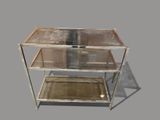 a metal shelf with two glass shelves on top of it
