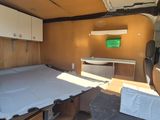a bed in the back of a van with a mattress on it