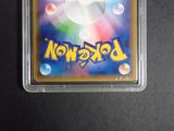 a close up of a pokemon card in a plastic case