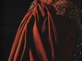 un livre sur lequel figure une robe rouge, posé sur une table