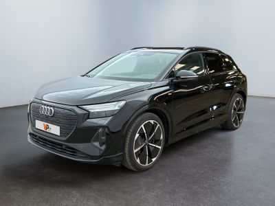 a black audi qx parked in a white room