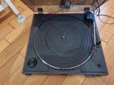 a record player that is sitting on a wooden floor