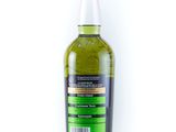 a bottle of green liquid sitting on top of a white surface