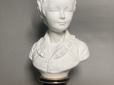 white porcelain bust of a woman on a black base
