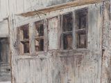 a painting of an old building with a door and windows