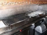 a grill that has a lot of food cooking on it