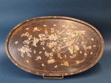 an old wooden tray with flowers and birds painted on it