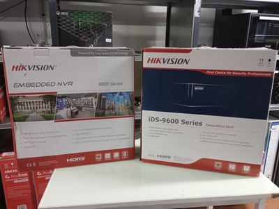 boxes on a table in a store with a television in the background
